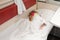 A child in train sleeping wrapped in a sheet in the lower place in the second-class compartment wagon