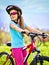 Child traveling bicycle in summer park.