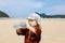 Child on tropical beach, drinking bottled water