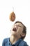 A child trying to bite a doughnut hanging from a hook