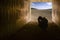 Child in tunnel and Cracked soil background with blue sky