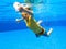 Child underwater in swimming pool. Kids swim