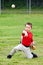 Child in uniform throwing baseball