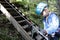 Child using carabiner on training route to rope park