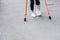 Child using crutches and broken legs for walking outdoor,Close up. broken leg, wooden crutches, ankle injury. Bone