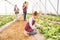 Child, vegetables in garden and greenhouse farm learning about organic agriculture, sustainable farming and food in