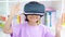 Child with virtual reality standing in library