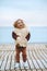 Child walking on the beach outdoor girl wearing fluffy sherpa jacket fashion outfit winter stylish clothing