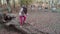 Child walking on a big tree trunk and jump in a woodland FDV