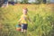 Child walking on a grass, playing