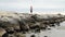 Child walks on the beach breakwaters