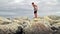 Child walks on the beach breakwaters