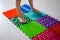 The child walks on a massage orthopedic foot mat. Prevention of flat feet