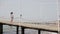 Child walks on a pier near the sea