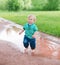 Child walks on the puddles