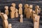 The child was lost in the crowd. A crowd of wooden figures of people surround a lost child. Lost kid