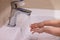 Child washes hands. Little girl washes her hands with soap under faucet with flowing water. Hygiene and health concept