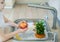 Child is washing an apple above kitchen sink. Washing and sanitizing fruits and vegetables in soapy water. Decontamination and