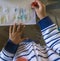 Child water painting as activity during pandemic lockdown