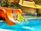 Child on water slide at aquapark.