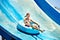 Child on water slide at aquapark.