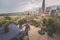 child watering flowers in huge terrace full of flowers