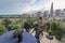 child watering flowers in huge terrace full of flowers