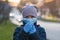 The child is wearing a protective mask and gloves. Protection against Chinese coronavirus . Care for future generations. The