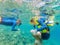 Child wearing snorkeling mask diving underwater