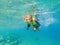 Child wearing snorkeling mask diving underwater