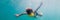 Child wearing snorkeling mask diving underwater BANNER, long format