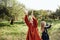 Child whirling, dancing plays on the meadow. Girl having fun with bubbles.