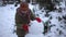 A child in the winter in the park sculpts a snowman.