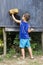 Child wiping blackboard in outdoor classroom