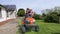 A Child and a woman on an Husqvarna TC 138 Ride-On Lawn Mower in UK on 2nd Aug 2020