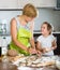 Child with woman making meat dumplings