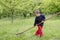 Child working in a garden with rake