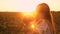 Child yawns in arms of the mother, baby wants to sleep, walk of mom and daughters at sunset in the park in summer