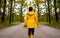 Child in yellow raincoat in forest