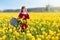Child in yellow tulip flower field in Holland