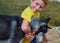 Child young boy hugs Siberian husky dog by the neck