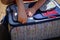 Child zipping a suitcase for travel