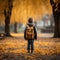 Childhood adventure Little boy with backpack explores autumn park