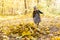 Childhood, autumn, people concept - child girl playing in autumn leaves