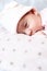 Childhood, care, motherhood, health concepts - Close up Little peace calm newborn baby girl in pink hat sleeps resting take deep
