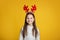 Childhood and children at Christmas concept. Cheerful small kid with horns and sweater