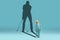 Childhood and dream about big and famous future. Conceptual image with boy and shadow of fit male golf player on blue