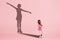 Childhood and dream about big and famous future. Conceptual image with girl and shadow of fit female figure skater on