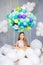 Childhood, dream and creativity concept - happy girl sitting in air balloon basket