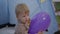 Childhood, handsome adorable male child plays with colored balloons